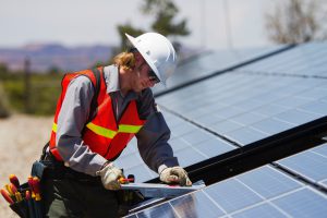 Solar technician checking solar array