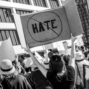 Protestor with *no hate* sign