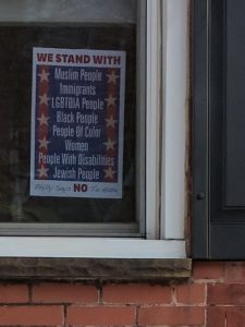 *We Stand With Everyone* sign in window